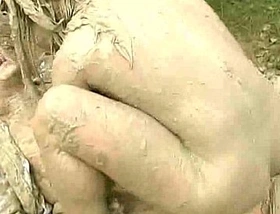 Muddy woman attacks and humps guy in the mud